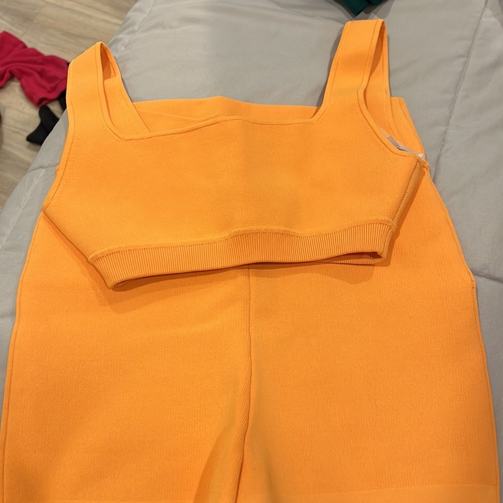 Kith orange workout set. Biker shorts and matching bra top.